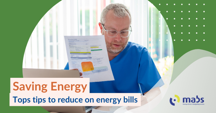 Blog post banner image contains an image of a a man reading his energy bill looking shocked. Text on the banner reads "Saving energy - Top tips to reduce your energy bills"