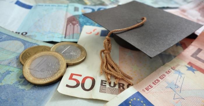 Euro notes and coins with a mortarboard