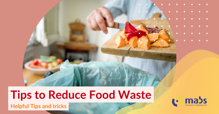 Cover image for the blog. The background is a pink hue. In the center image holds a woman scraping the unwanted ends of vegetables into a bin. The caption reads "Time to reduce food waste - Hekpful Tips and Tricks"
