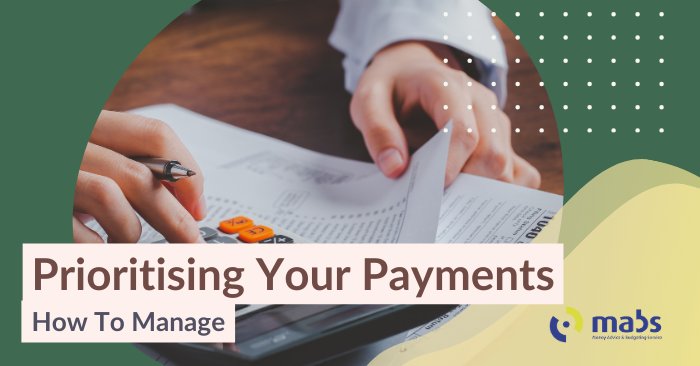 Cover image for blog holds a image in the center. The image is a hand using a calculator and looking at a page of expenses. Title reads ' Prioritising Your Payments - how to manage'