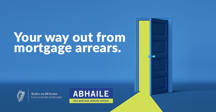 Graphic of a slightly open door with a bright yellow light shining through casting a light stream across the ground in front of the open door. The title "Your way out from mortgage arrears." The Government of Ireland and Abhaile logos at the bottom left hand corner.