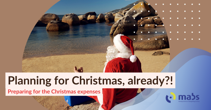 Cover image for blog post. Text reads "Planning for Christmas, already?! - Preparing for the Christmas expenses". Center image holds a Santa Claus lying out on a beach in the sun, resting his feet on a drinks cooler, while looking onto the water.